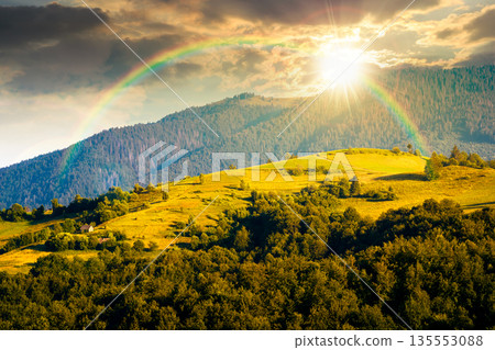 mountainous countryside landscape with rolling hills on summer sunset. rural area in evening light. beautiful view of place with green grassy pastures. storytelling cinematic image under the rainbow mountainous countryside landscape with rolling hills on summer sunset. rural area in evening light. beautiful view of place with green grassy pastures. storytelling cinematic image under the rainbow 135553088