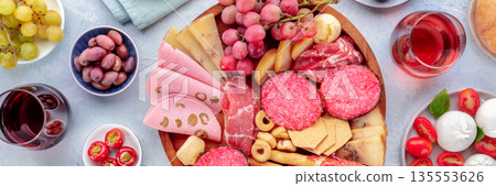 Italian Antipasti panorama. Charcuterie platter with cheese and other snacks Italian Antipasti panorama. Charcuterie platter with cheese and other snacks 135553626