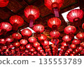 Chinese red lamps with bright light inside hanging on the ceiling of the scared temple building. 135553789