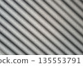 Rough cement wall in grey color covered by shadow in stripped lines from the sunlight through the window. 135553791
