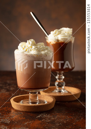 Creamy milk chocolate drinks with whipped cream. 135553814
