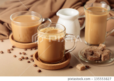 Latte with brown sugar on a beige background. 135553827