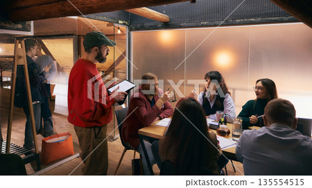 Creative professionals brainstorming together in modern office interior. 135554515