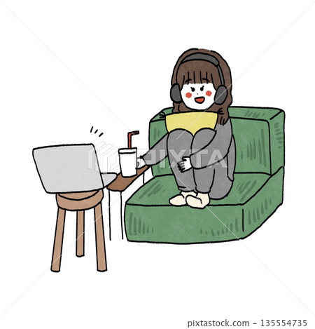Girl sitting on sofa watching movie with headphones 135554735