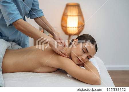 Neck massage. Relaxed young woman is with therapist in spa salon 135555552