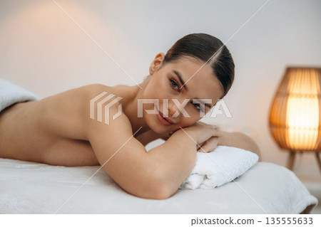 Relaxing, waiting. Beautiful young woman lying on a couch in a spa salon Relaxing, waiting. Beautiful young woman lying on a couch in a spa salon 135555633