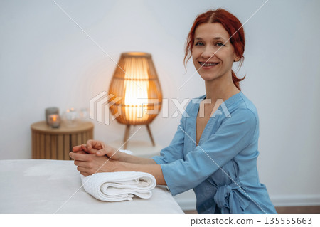 Fresh towels. Dermatologist, also skilled as a cosmetologist and beautician, poses for a portrait in beauty salon office 135555663