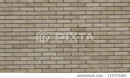 Beige brick wall with neat rows of rectangular blocks in different shades of brown and gray as an empty textured street building design background 135555881