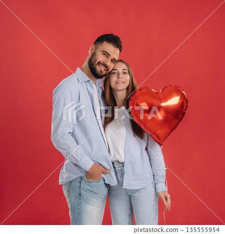 Posing, holding balloon. Lovely couple are together in the studio 135555954