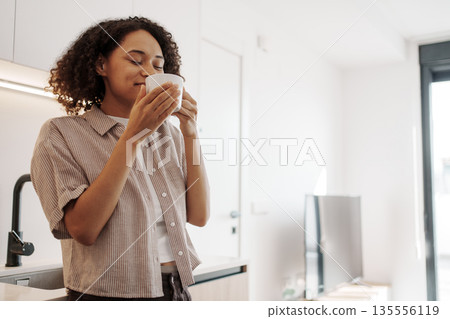 Calm Aromatic Ritual, Tranquil Woman Relaxes With Fragrant Mug Instructions In Comforting Environment 135556119