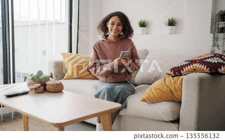 Morning Leisure Activity, Woman Relaxes On Couch Enjoying Calm Morning With Sunlight And Greenery 135556132