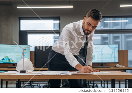 Man is working in the wind turbine company 135556355