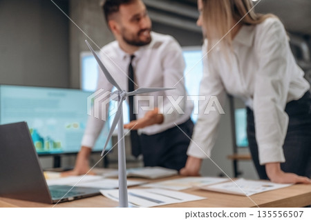 Having a conversation. Two employees are working in wind turbine company Having a conversation. Two employees are working in wind turbine company 135556507