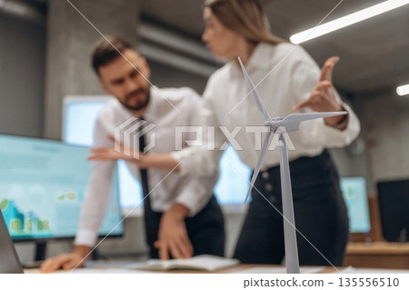 Having a conversation. Two employees are working in wind turbine company 135556510