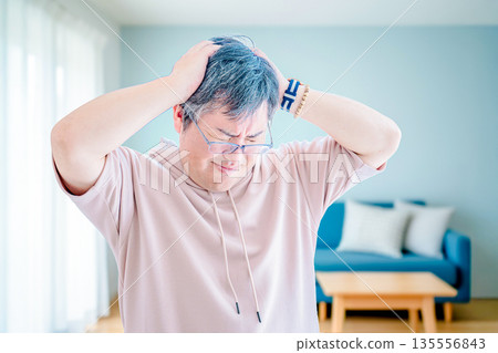 Man holding his head Man holding his head 135556843