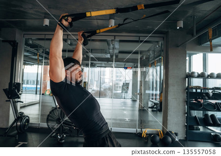Flexibility and strength. Man is in the modern gym 135557058