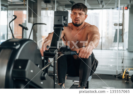 Preparing, doing cardio. Man is in the modern gym 135557065