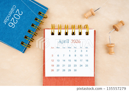 April 2026 desk calendar with wooden thumbtack on brown paper. April 2026 desk calendar with wooden thumbtack on brown paper. 135557279