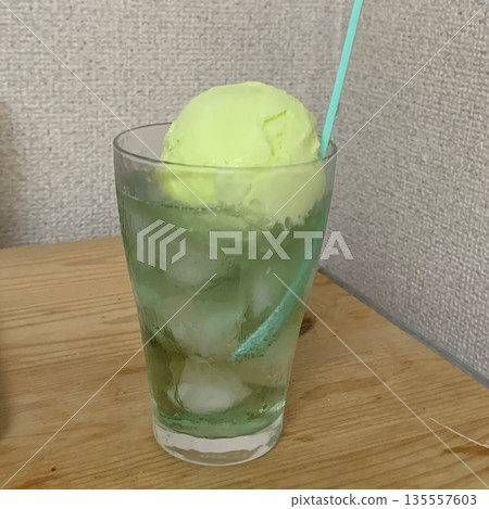 Melon soda and melon ice cream poured into a glass with ice Melon soda and melon ice cream poured into a glass with ice 135557603