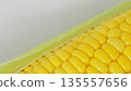 Close-up of fresh sweet corn kernels with green husk on white background. 135557656