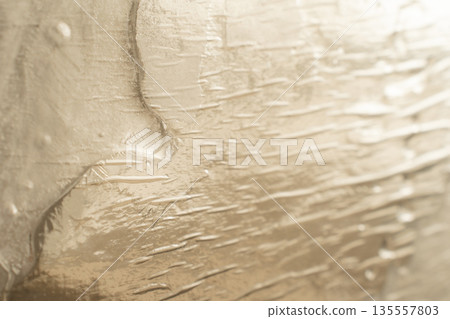 Warm gold abstract texture with soft relief Warm gold abstract texture with soft relief 135557803