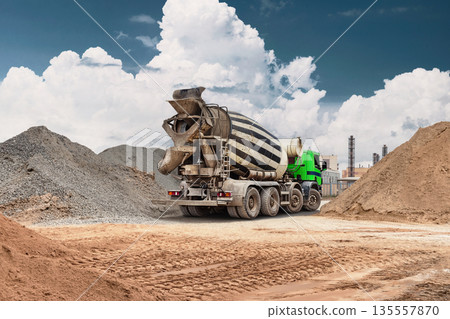 A concrete mixer truck stands at the construction site. The heavy equipment works efficiently, moving materials and supporting ongoing projects 135557870