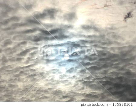 A sky with light shining through thin clouds A sky with light shining through thin clouds 135558101