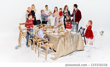 Warm family celebration with food table and festive decorations. 135558338
