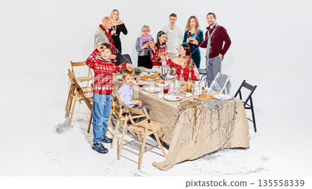 Large family home party with kids playing during holiday dinner. 135558339