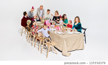 Happy family birthday gathering with children and festive atmosphere Happy family birthday gathering with children and festive atmosphere 135558379