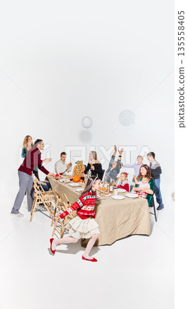 Relaxed family gathering with playful children during meal. Relaxed family gathering with playful children during meal. 135558405