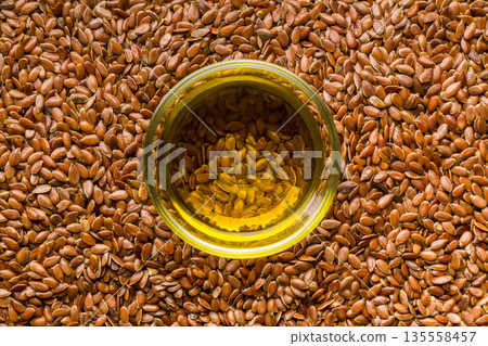 Brown linseed or flaxseed and oil. Healthy flax seed. Top view. Brown linseed or flaxseed and oil. Healthy flax seed. Top view. 135558457