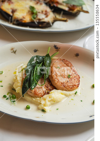 Pork medallions with mashed potatoes and spinach 135558634