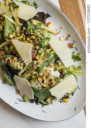 Fresh green salad with parmesan and seeds Fresh green salad with parmesan and seeds 135558662
