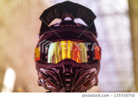 Closeup of black motocross helmet with reflective visor Closeup of black motocross helmet with reflective visor 135558750