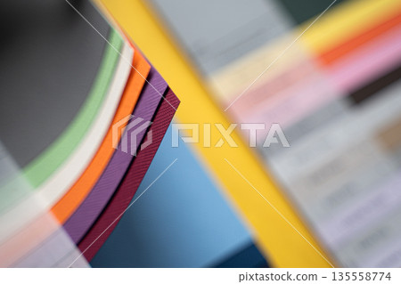 Closeup of layered print production sampler with textured paper swatches in various colors Closeup of layered print production sampler with textured paper swatches in various colors 135558774