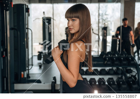 Young woman is in the gym 135558807