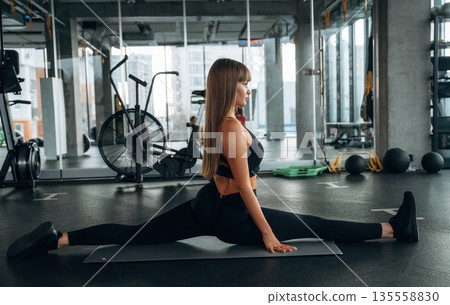 Wide twine. Young woman is in the gym Wide twine. Young woman is in the gym 135558830