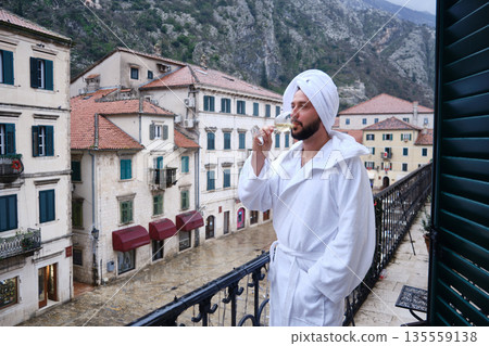 Man Drinking Wine on Balcony in Historic Old Town Man Drinking Wine on Balcony in Historic Old Town 135559138