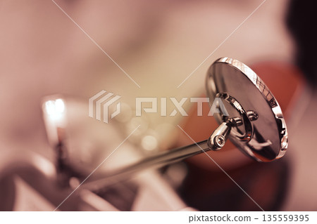Closeup of a vintage motorcycle rearview mirror with chrome finish 135559395