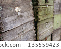 Close up of weathered old wooden beehive boxes stacked outdoors 135559423