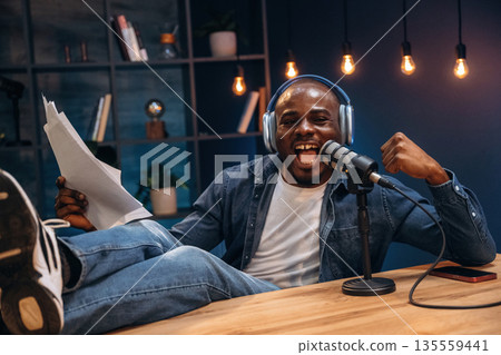 Black man is doing podcast in the studio 135559441