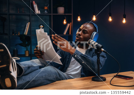 Man is doing podcast in the studio 135559442