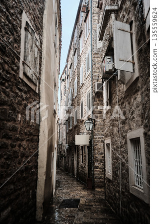 Narrow Stone Alleyway in Old Town District 135559624