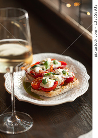 Bruschetta with tomatoes mozzarella and basil 135559935