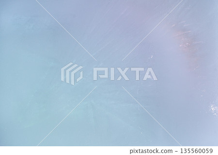 A background of delicate blue and pink ice with a subtle texture. A soft pastel abstract texture with a subtle glow 135560059