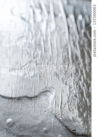 Liquid silver metal texture creating abstract background design 135560063