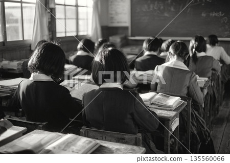 Back view of students reading textbooks in the classroom. Monochrome classroom scene. Wooden school building. 135560066