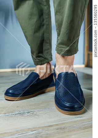 Male legs in blue leather shoes. Men's classic shoes. Male legs in blue leather shoes. Men's classic shoes. 135560295