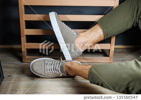 Collection of men's summer shoes. Male legs in beige leather sneakers. Men's classic shoes. Collection of men's summer shoes. Male legs in beige leather sneakers. Men's classic shoes. 135560347
